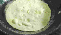 Cooking and roasting round shaped roti in a tawa for tandoori roti recipe