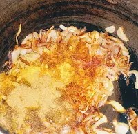 Mixing cumin powder,red chilli, biryani masala, turmeric powder for veg biryani recipe using pressure cooker
