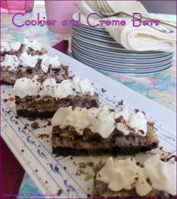 Cookies and Creme Bars: chocolate cookie chunks in a cookies and crème flavored center with a chocolate crust. Serve topped with whipped cream, of course. | Recipe developed by www.BakingInATornado.com | #recipe #dessert
