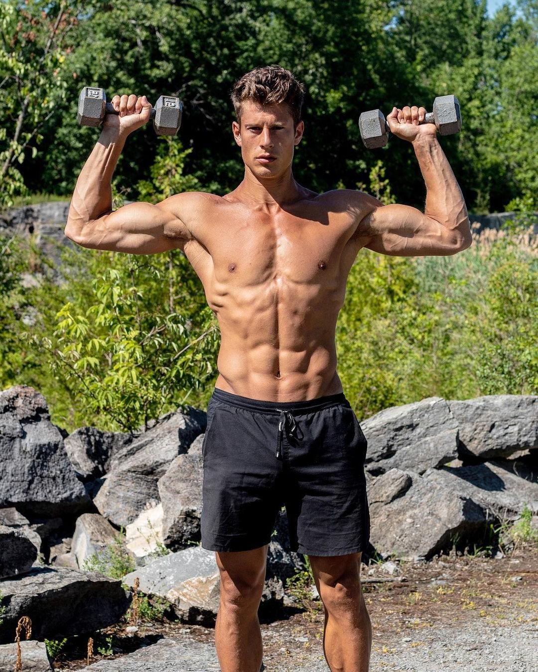 sexy-shirtless-ripped-body-male-model-listing-weights-outdoors