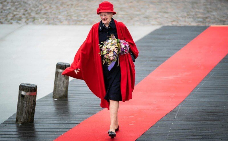 Queen Margrethe wore a red wool cape and hat. Crown Princess Mary