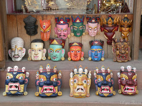 Different types of traditional Nepalese wooden masks on sale 