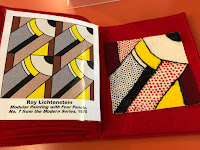 a two page spread with a printed image of the art work by Roy Lichtenstein, titled Modular Painting with Four Pencils, No. 7 from the Modern Series, 1970, on the left. There are images of 4 pencils. On the right side is a tactile representation made from puffy paint and flannel pieces in red, black, and blue to create a pencil shape point up