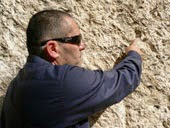 Simon pointing at the seal in the wall of the garden tomb