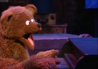 Baby bear plays the piano and he sings about learning alphabet. Sesame Street Do the Alphabet