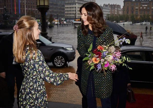 Crown Princess Mary wore a tweed coat from Prada, and yellow suede pumps from Gianvito Rossi