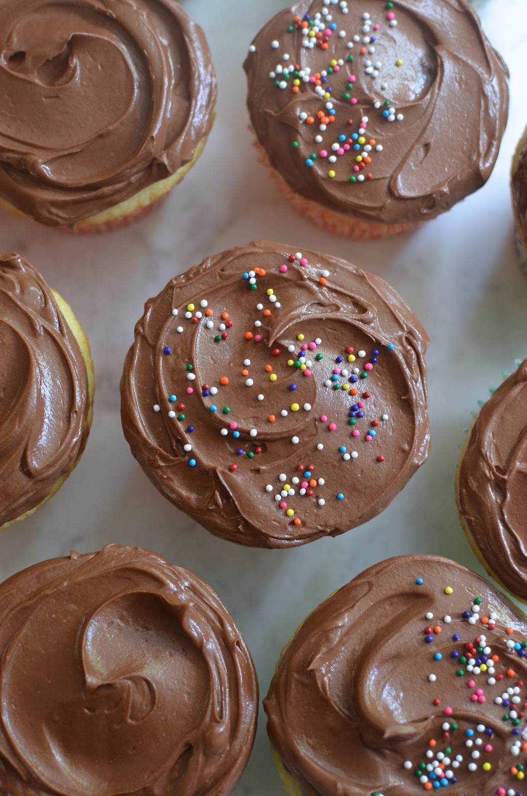 Playing with Flour Vanilla cupcakes with chocolate frosting