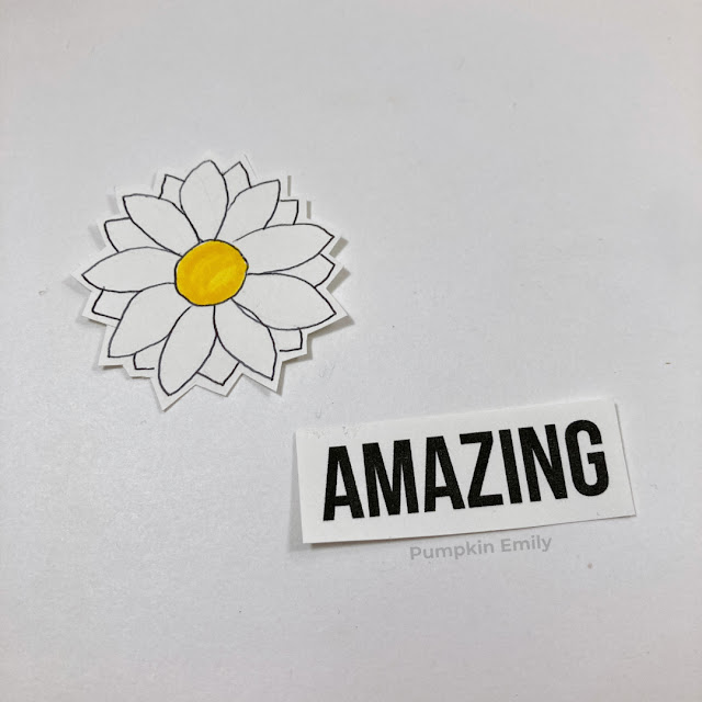 A flower and an amazing sticker made out of sticker paper.