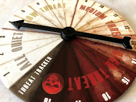 The threat tracker dial from The Walking Dead: All Out War miniatures game