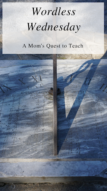 text: Wordless Wednesday: A Mom's Quest to Teach; sun dial photograph