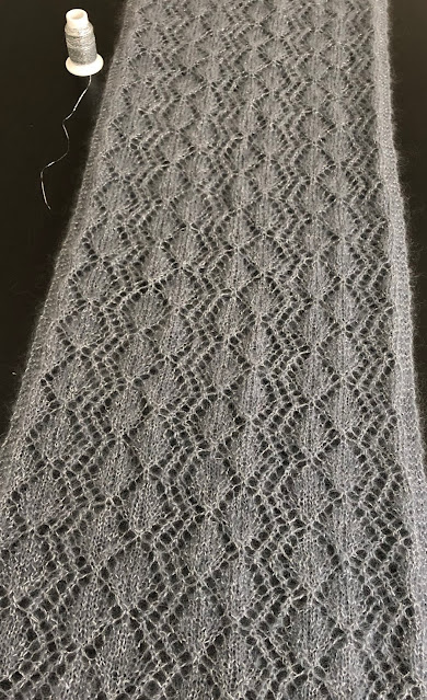 Lace shawl knitted with DROPS Kid Silk and Glitter