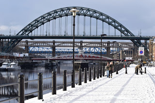 Snowy path on the Quayside and in the background some of the many bridges crossing the River Tyne