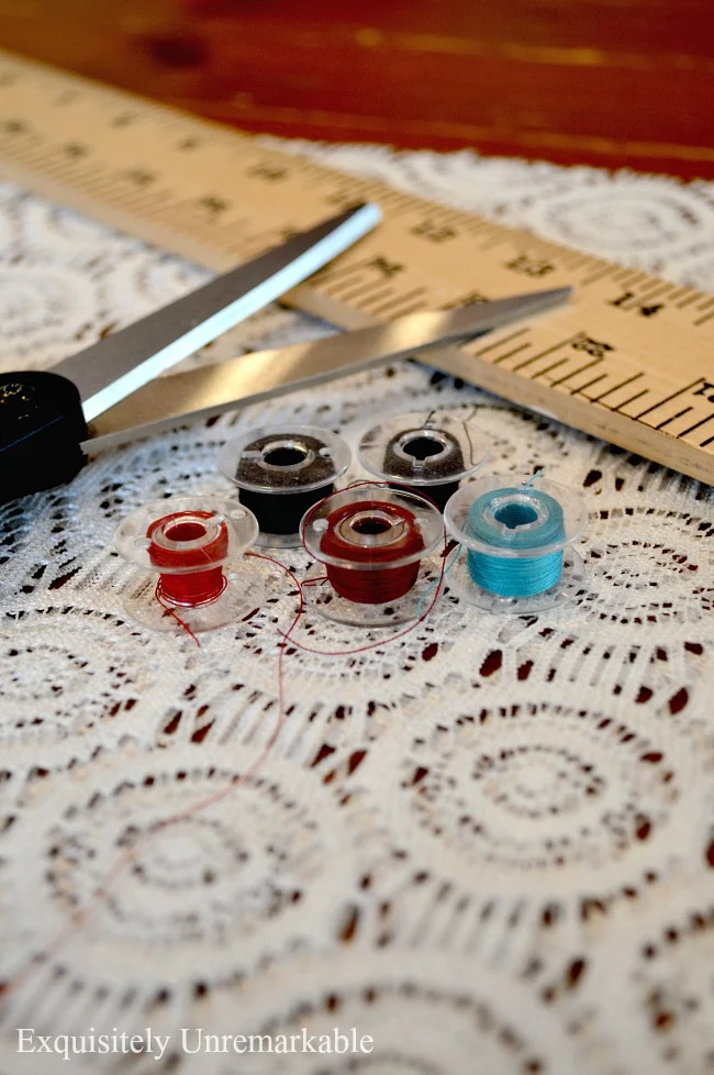 Colored Bobbins On  A Lace Fabric