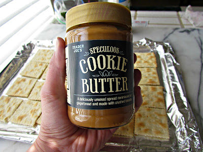 Jar of cookie butter held in a hand.