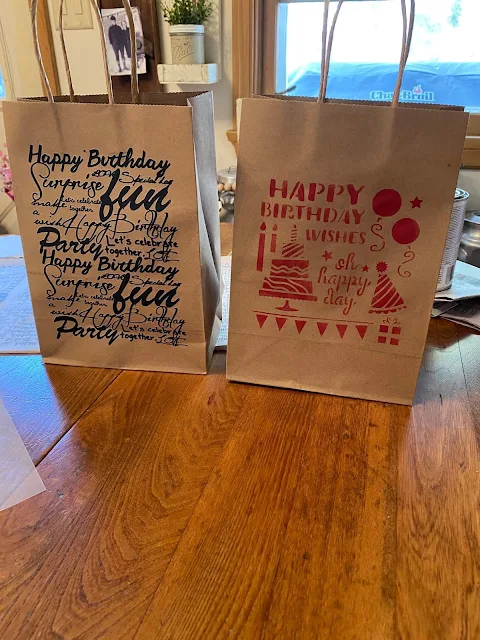 Photo of plain gift bags with a rub on transfer & a stencil