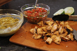 ingredients - guacamole in bowl, pico in bowl, shredded chicken on cutting board