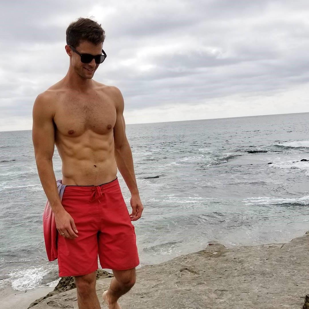 hairy-bare-chest-tall-young-dude-pecs-sunglasses-red-shorts-walking