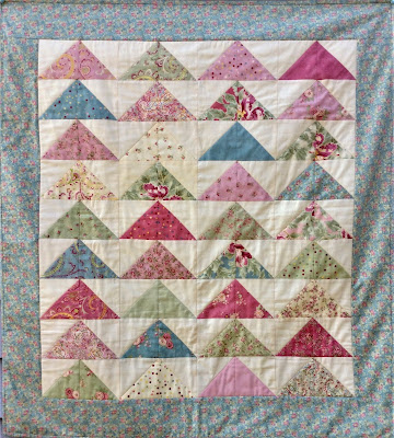 A lap quilt made from charm squares - Free Pattern A lap quilt of triangles made from charm squares