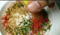 Adding lemon juice over spied ground chicken for chicken seekh kabab recipe