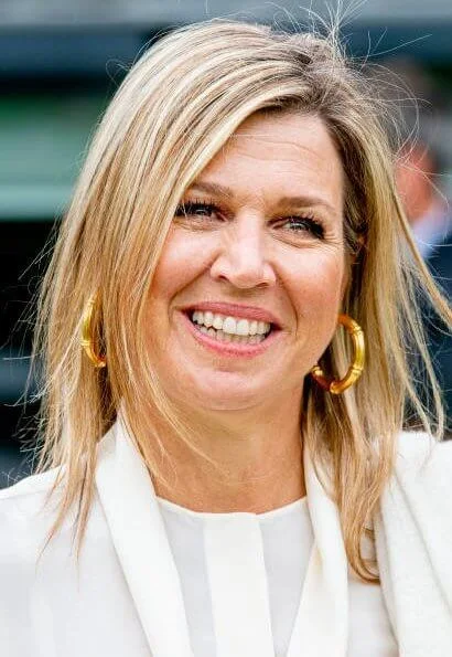 Queen Maxima wore Massimo Dutti ivory silk blouse with bow and trousers, Cartier Gold Bamboo earrings