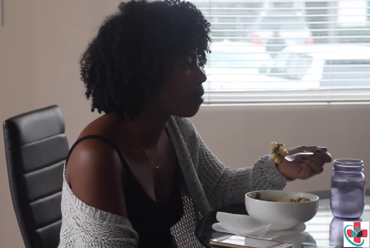 Black woman struggling to eat