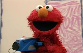 Elmo has a home video. Elmo makes a video with his camera. Elmo's World Balls Home Video