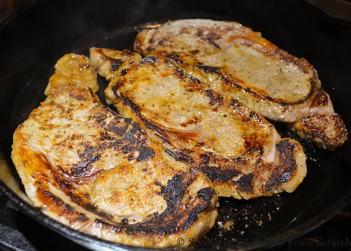 3 Boneless Rib Eye Steaks Pan Seared in a cast iron frying pan.