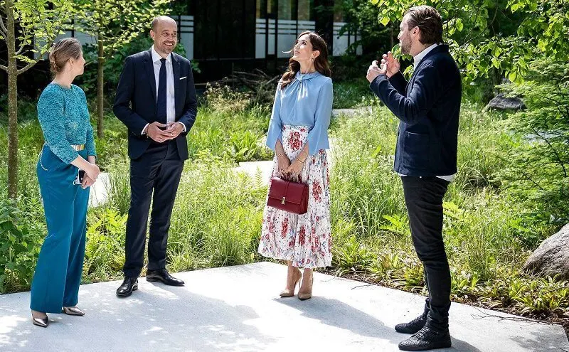 Crown Princess Mary wore a flare sleeve knot blouse from Victoria Beckham, and sunray pleated scarf print skirt from Paul and Joe