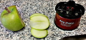 the anysharp knife sharpener along with a sliced apple