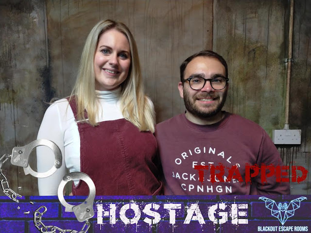 Couple trapped in escape room, smiling
