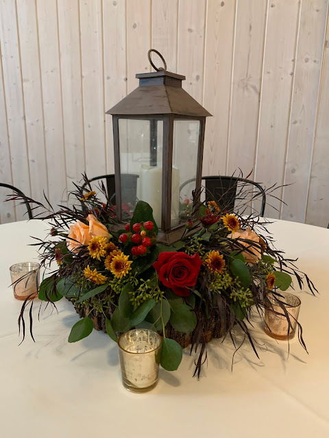 Lantern centerpiece with fall flowers