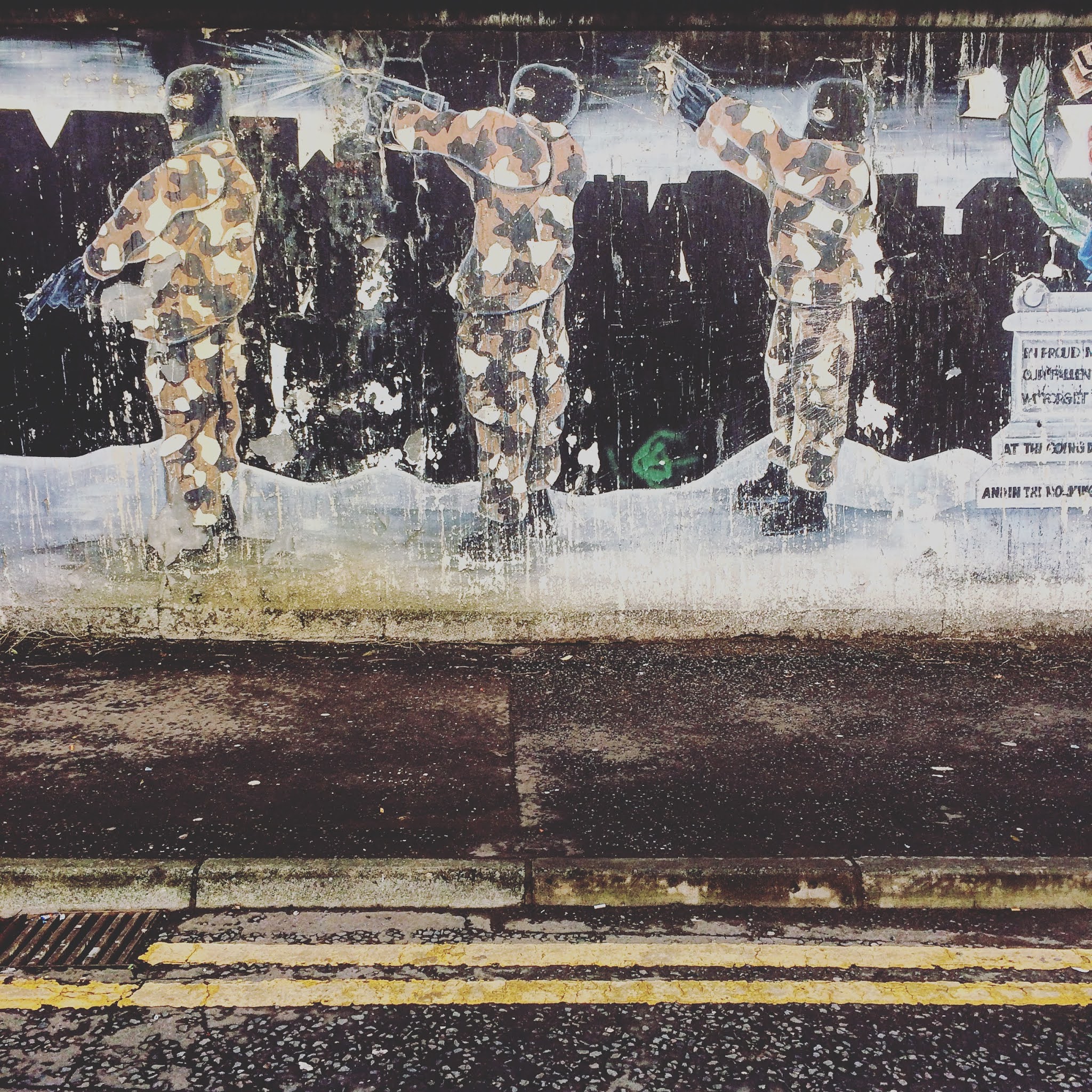 mural of men wearing camouflage firing guns in belfast city