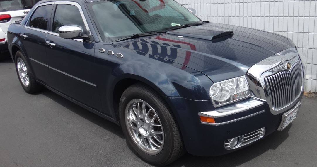 Just A Car Guy Fake hood scoop and Buick portholes on a Chrysler 300? That's not right