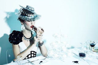 woman eating spider, haute couture, fashion photography, dinner table