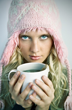 Female with Hat Holding a cup of Green Tea