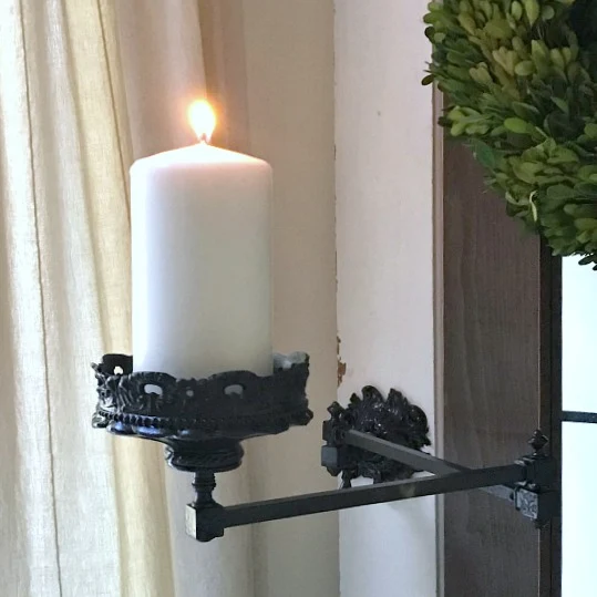 Folding arm candle holder