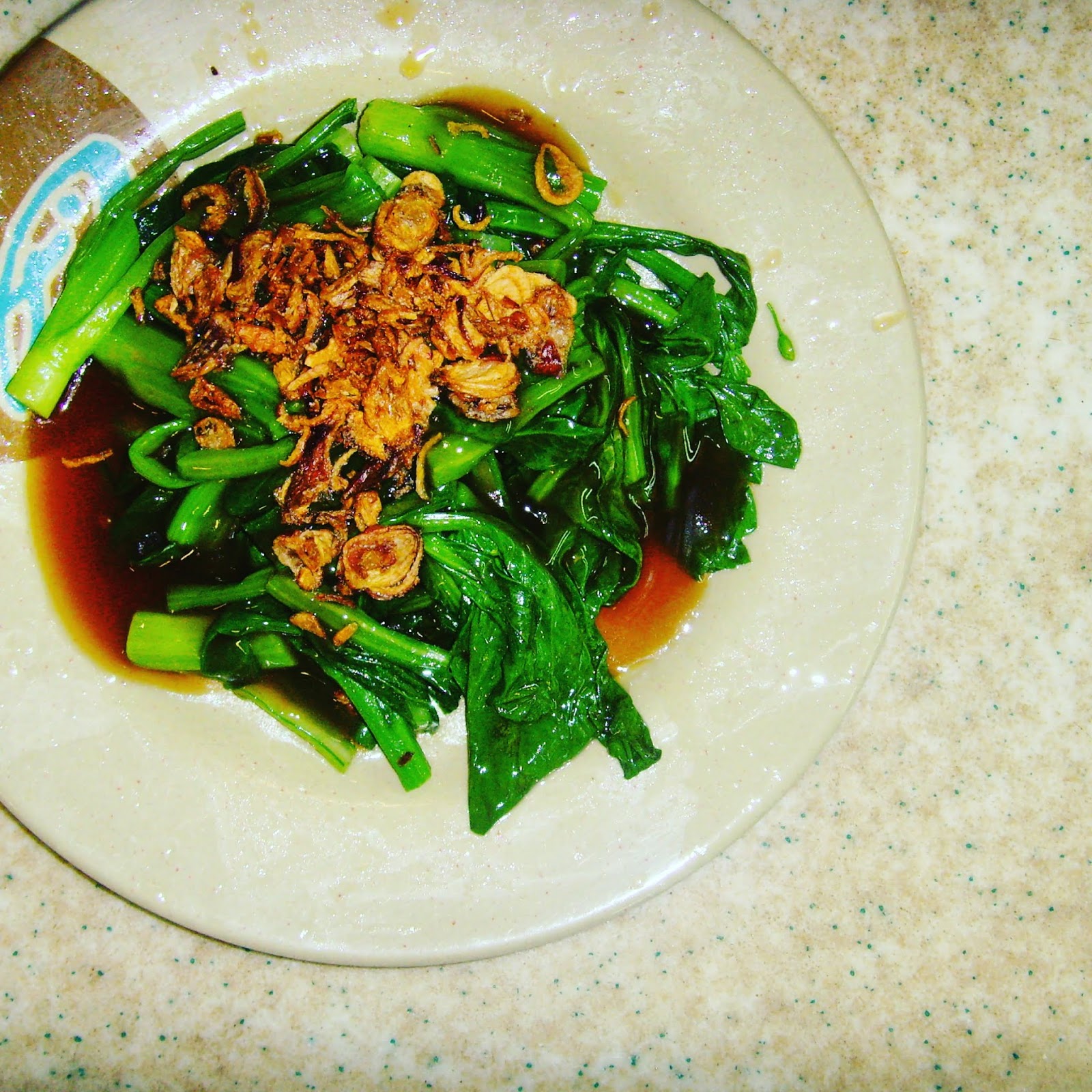 chinese broccoli and soy on brown plate singapore