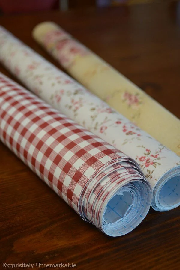 Three rolls of checked and floral contact paper