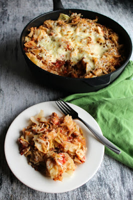 Get the flavor of cabbage rolls without the work! Un-stuffed cabbage casserole is a quick and easy one pan dinner that makes cabbage roll goodness possible on a weeknight! plate of stuffed cabbage roll casserole in front of skillet of remaining dinner
