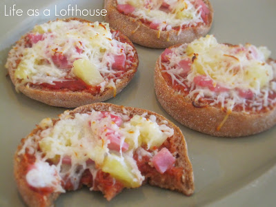 Mini Hawaiian Pizzas are little pizzas covered in a homemade pizza sauce and topped with cheese, pineapple tidbits and Canadian ham. Life-in-the-Lofthouse.com