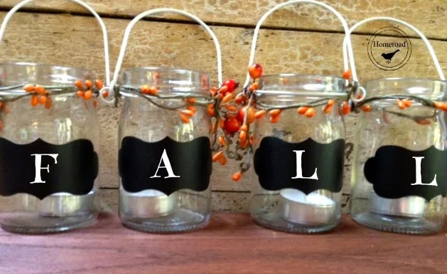 Row of hanging jars with pip berries and labels that say FALL