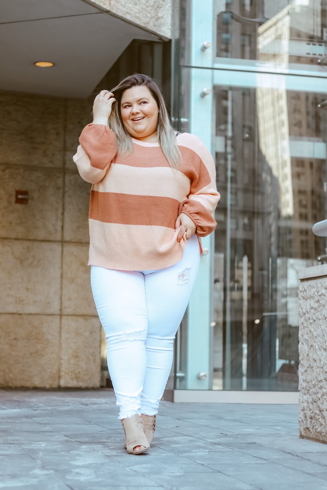 Chicago Plus Size Petite Fashion Blogger, influencer, YouTuber, and model Natalie Craig, of Natalie in the City, reviews Chic Soul's white skinny jeans and a striped sweater.