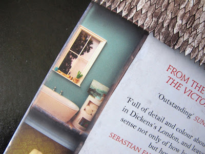Back cover of a book, showing a picture of a miniature bathroom.