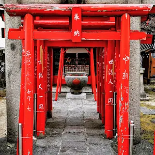 Red tori gates at a small shrine in Matsumoto Japan
