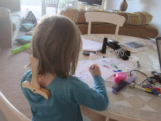 Mabel with Dash's wooden sword down the back of her shirt