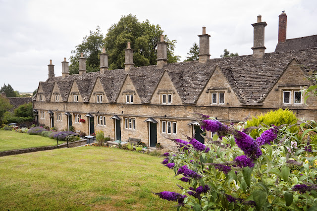 Almshouses at Chipping Norton with flowers in bloom by  Martyn Ferry Photography