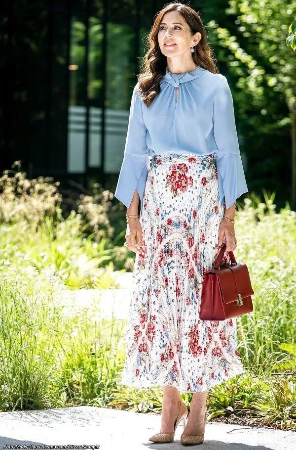 Crown Princess Mary wore a flare sleeve knot blouse from Victoria Beckham, and sunray pleated scarf print skirt from Paul and Joe