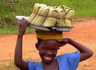 Selling fish and rice wrapped with banana leaves in Ghana