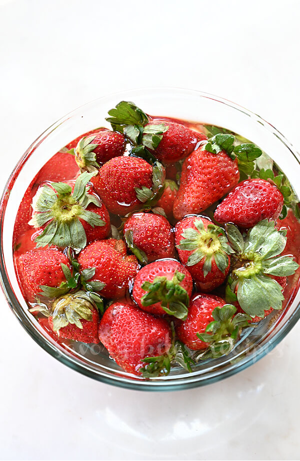 a close up of bowl with fresh strawberry