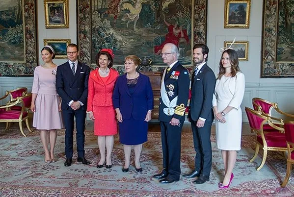 Crown princess Victoria, Prince Daniel, Prince Carl Philip and his wife Princess Sofia welcomed Chilean President Michelle Bachelet. Princess Victoria wore The Fold London Camelot Dress